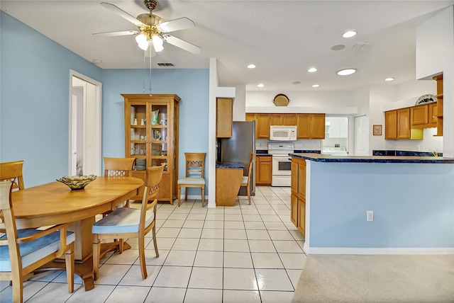 kitchen featuring ceiling fan, light tile patterned floors, and white appliances