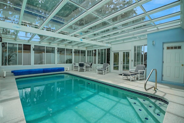 view of pool with a skylight and french doors