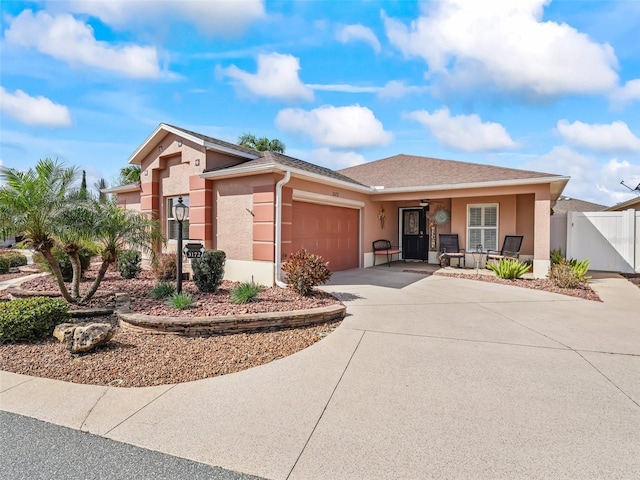 single story home with a garage and covered porch