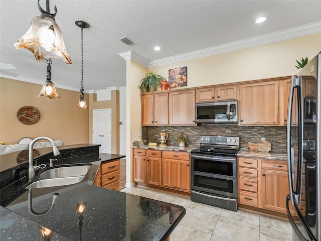 kitchen featuring pendant lighting, sink, stainless steel appliances, and dark stone countertops