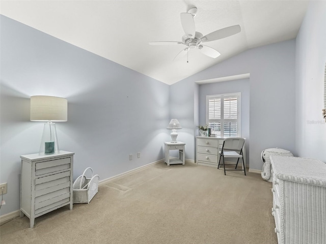 sitting room with lofted ceiling, light colored carpet, and ceiling fan