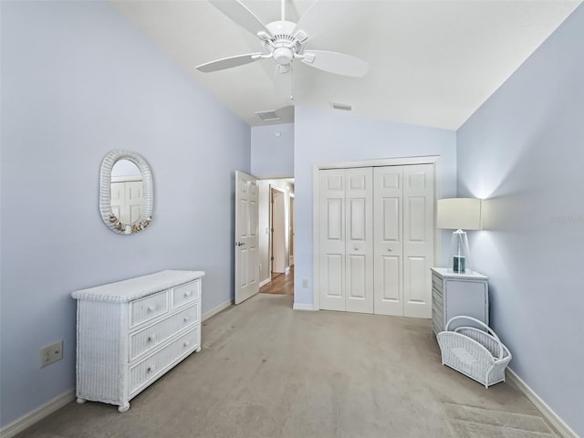 carpeted bedroom with lofted ceiling, ceiling fan, and a closet