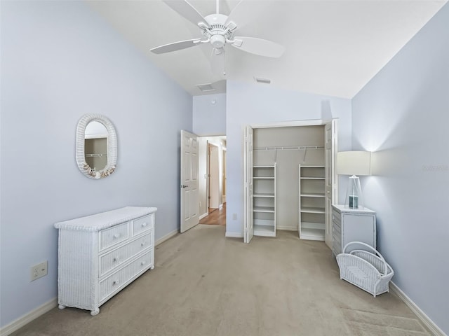 carpeted bedroom featuring ceiling fan, lofted ceiling, and a closet