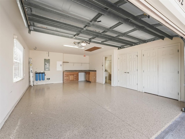 garage featuring a garage door opener and electric panel