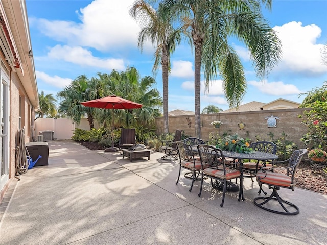 view of patio with an outdoor fire pit and central air condition unit