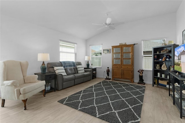 living room featuring ceiling fan, lofted ceiling, and wood-type flooring