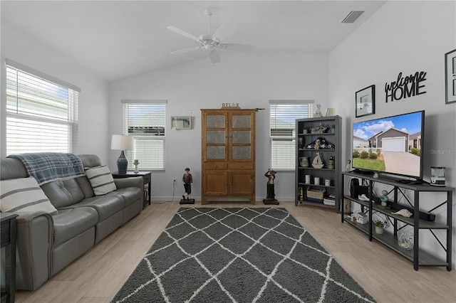 living room with ceiling fan, lofted ceiling, and light wood-type flooring