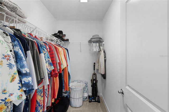 walk in closet featuring carpet flooring