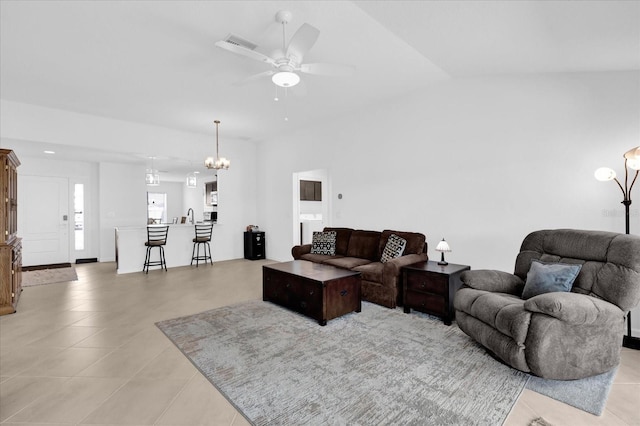 1392 Kenneth St, The Villages, FL 34762 - tiled living room featuring ceiling fan with notable chandelier and vaulted ceiling