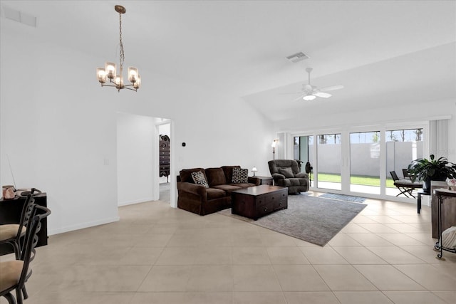 1392 Kenneth St, The Villages, FL 34762 - living room with ceiling fan with notable chandelier, vaulted ceiling, and light tile patterned floors