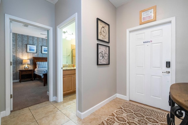 entryway with light tile patterned floors