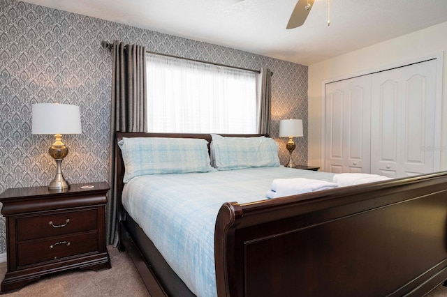 carpeted bedroom with ceiling fan and a closet