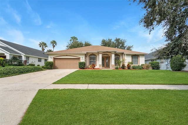 ranch-style house featuring a garage and a front lawn