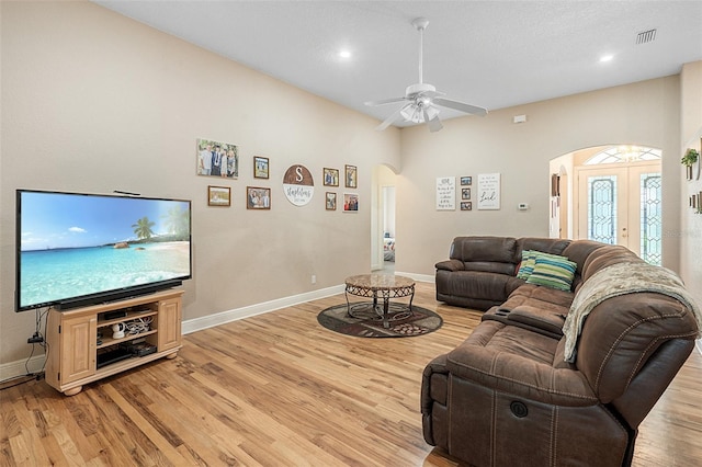 living room featuring french doors, ceiling fan, and light hardwood / wood-style floors