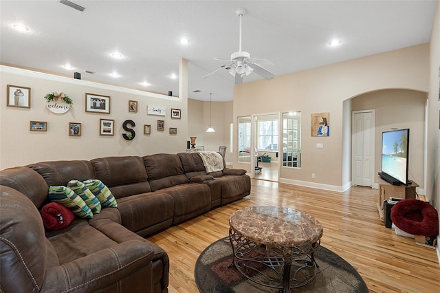 living room featuring ceiling fan and light hardwood / wood-style floors