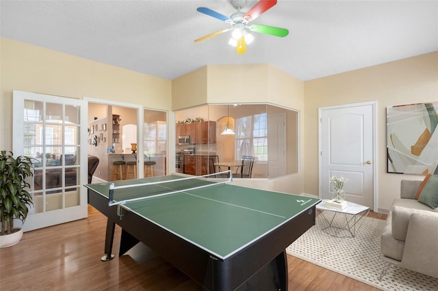 recreation room featuring a healthy amount of sunlight, wood-type flooring, and ceiling fan