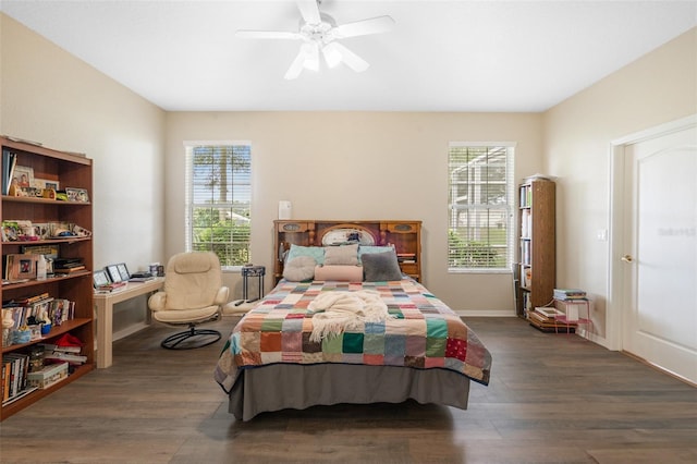 bedroom featuring multiple windows, dark hardwood / wood-style flooring, and ceiling fan