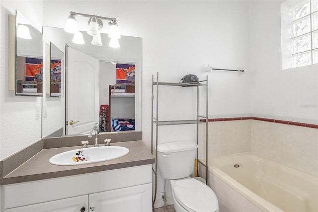 bathroom with a relaxing tiled tub, vanity, and toilet