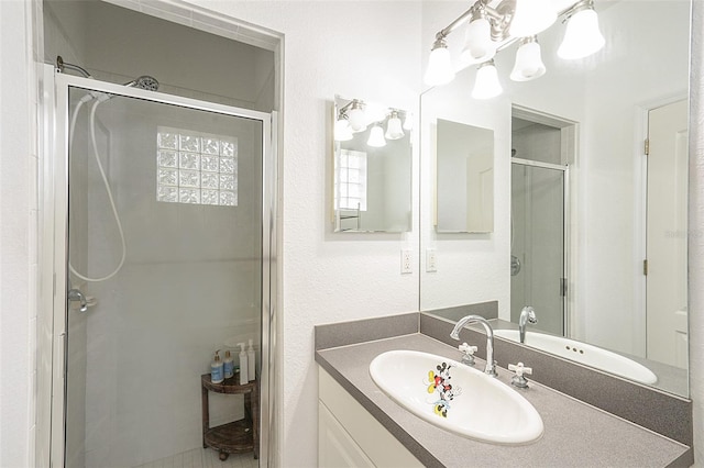 bathroom featuring vanity and a shower with shower door