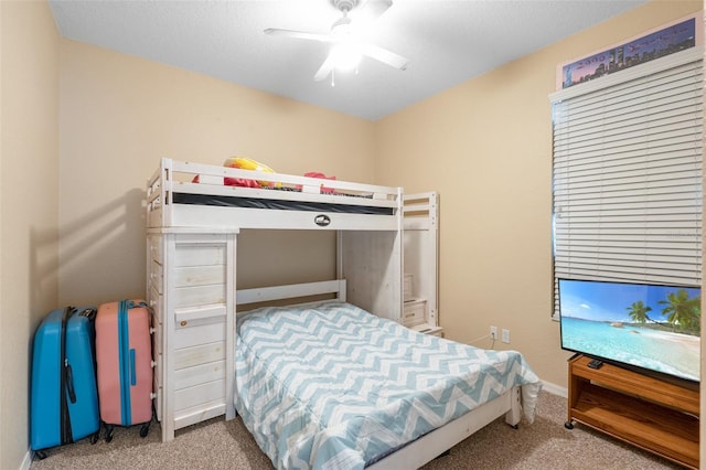 carpeted bedroom featuring a textured ceiling and ceiling fan