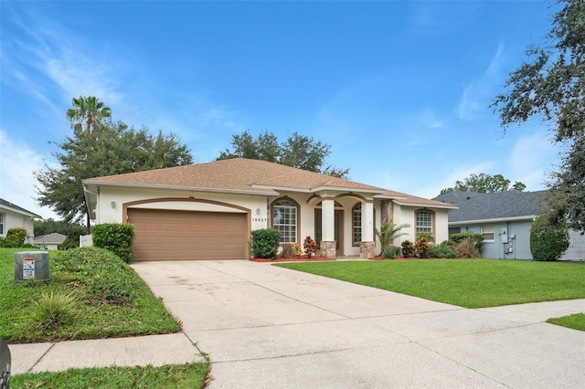 view of front of home featuring a garage and a front lawn