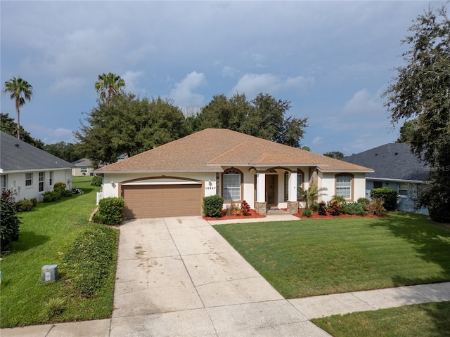 ranch-style house featuring a garage and a front lawn