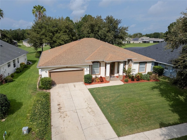 single story home with a garage and a front yard