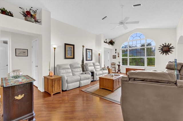 living room with vaulted ceiling, dark hardwood / wood-style floors, and ceiling fan