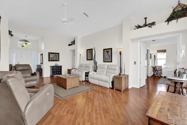 living room featuring hardwood / wood-style flooring, vaulted ceiling, and ceiling fan