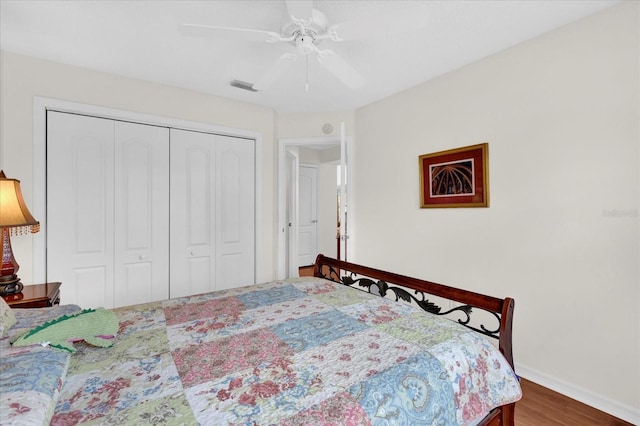 bedroom featuring hardwood / wood-style flooring, ceiling fan, and a closet