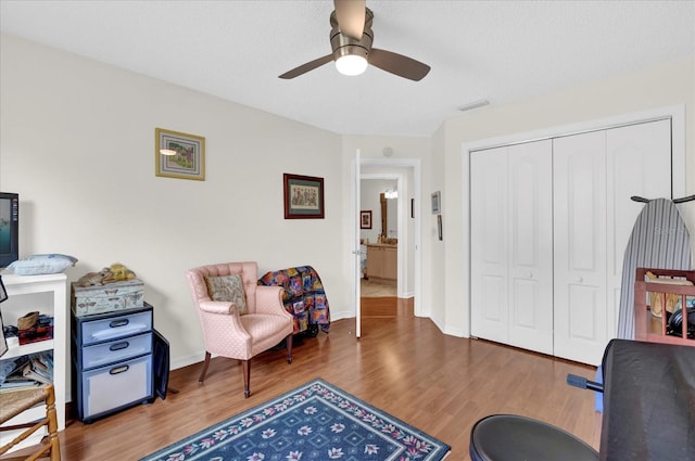 home office featuring a textured ceiling, wood-type flooring, and ceiling fan