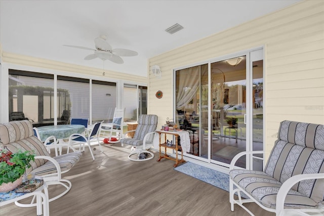 sunroom featuring ceiling fan