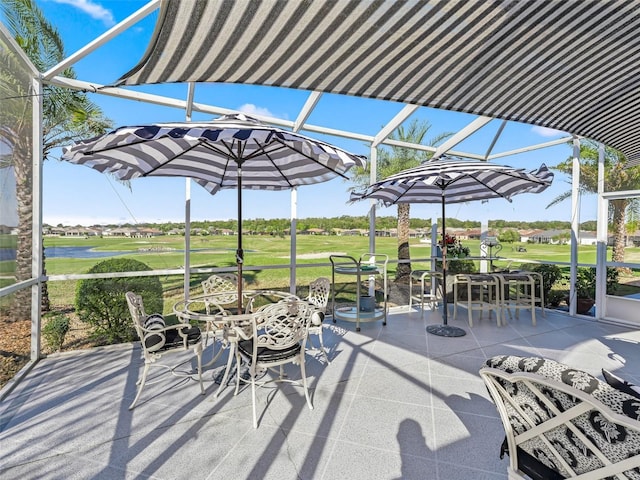 view of patio with view of golf course and outdoor dining area