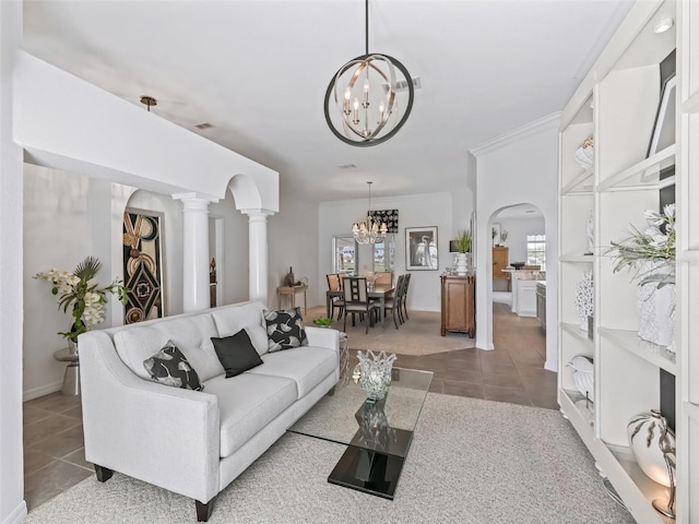 living area featuring tile patterned flooring, arched walkways, a notable chandelier, and ornamental molding