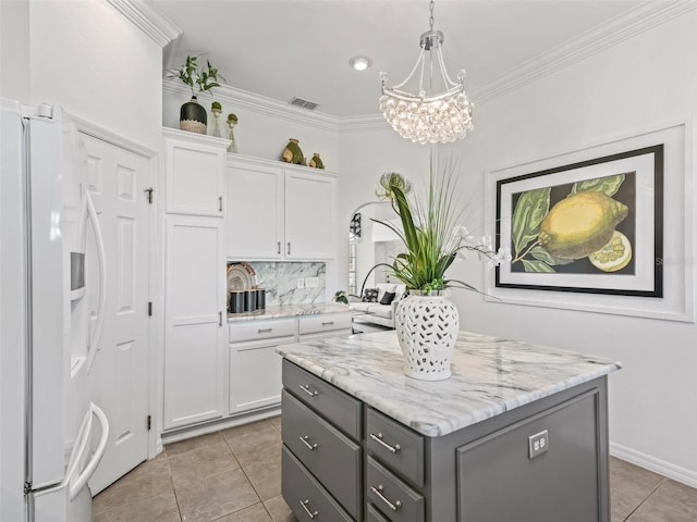 kitchen with visible vents, decorative light fixtures, gray cabinetry, white fridge with ice dispenser, and white cabinetry