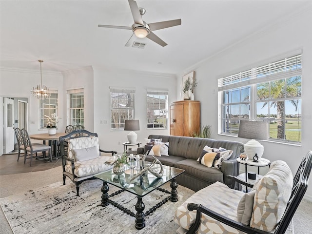 living area featuring ceiling fan with notable chandelier, visible vents, and crown molding