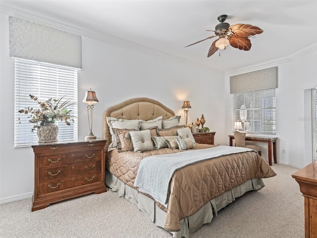 bedroom with ceiling fan, baseboards, crown molding, and light colored carpet