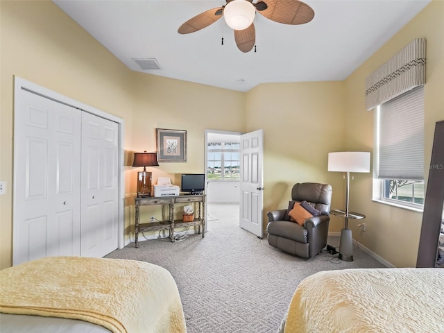 carpeted bedroom featuring baseboards, visible vents, ceiling fan, and a closet