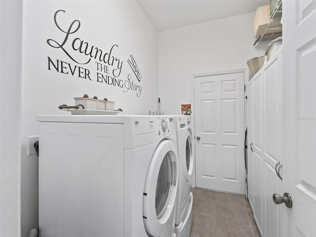 laundry room with cabinet space, washer and clothes dryer, and light tile patterned flooring