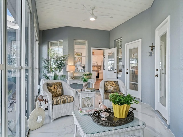 sunroom featuring ceiling fan and french doors