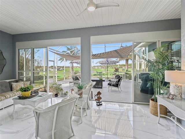 sunroom featuring a ceiling fan