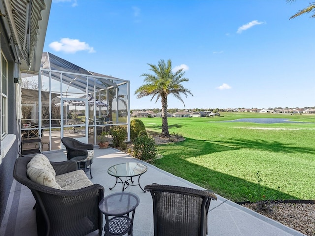 view of patio / terrace featuring view of golf course and glass enclosure