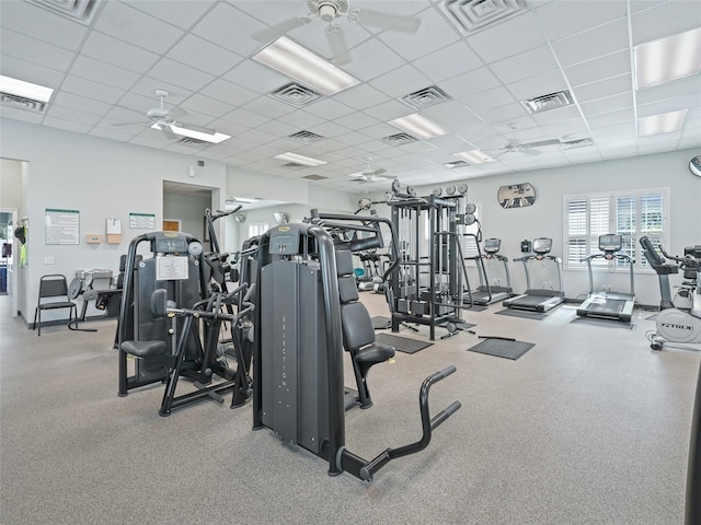 exercise room featuring a paneled ceiling, visible vents, and a ceiling fan