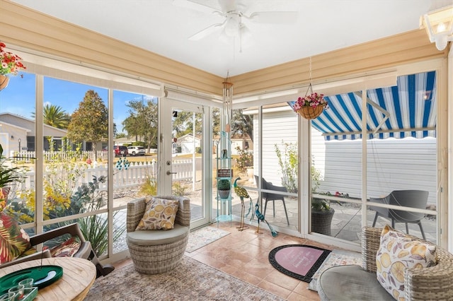 sunroom / solarium featuring ceiling fan