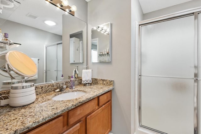 bathroom with vanity and an enclosed shower