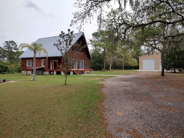 view of front of house with a garage, an outdoor structure, and a front lawn