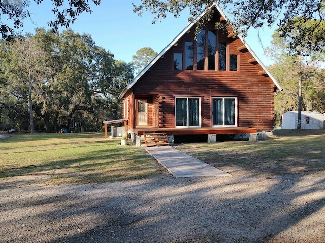 rear view of house featuring a yard and log exterior