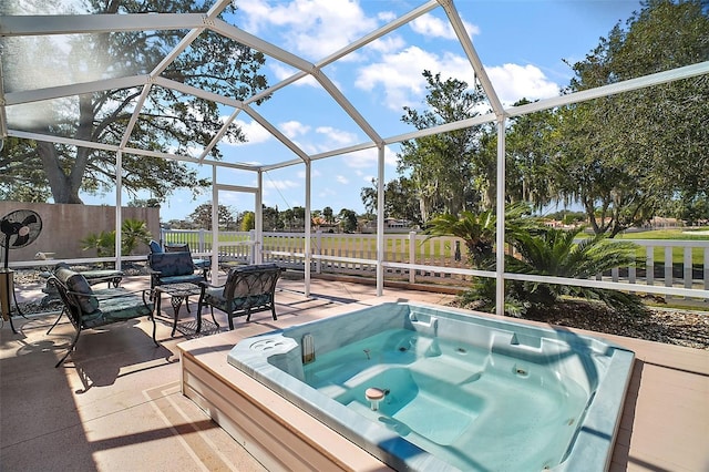 view of swimming pool featuring a patio area, a lanai, an outdoor hot tub, and fence