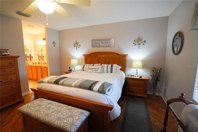 bedroom featuring ceiling fan, connected bathroom, and dark hardwood / wood-style floors