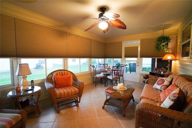 sunroom / solarium with a water view and ceiling fan